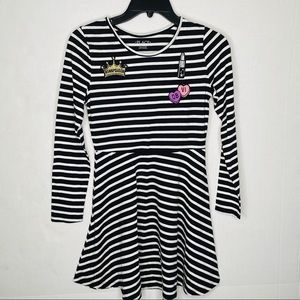 Black lined dress with cute accessory on it